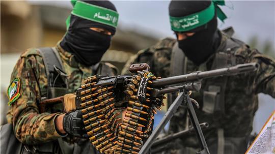  Vermummte Kämpfer der Kassam-Brigaden, des militärischen Flügels der islamistischen Terrororganisation Hamas, hantieren mit Waffen.
