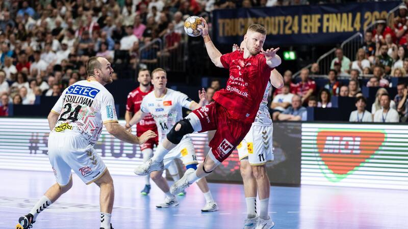 Aalborgs Sebastian Barthold (r) wirft neben Magdeburgs Christian O’Sullivan (l) auf das Tor.