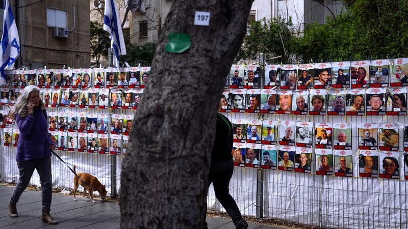 An einem Zaun in einem Vorort von Tel Aviv sind Fotos von Israelis angebracht sind, die im Gazastreifen von der islamistischen Hamas als Geiseln festgehalten werden.