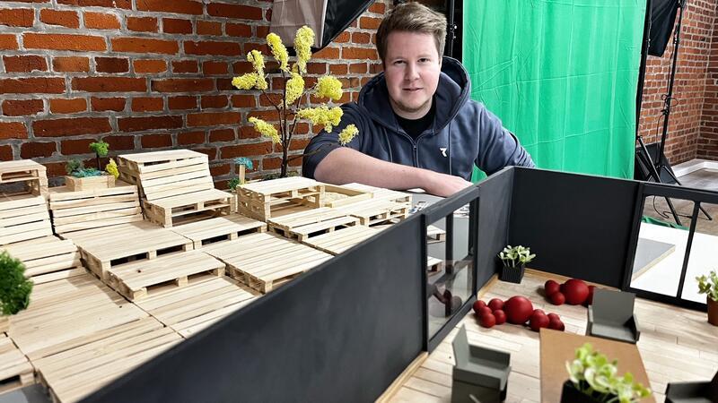 Ankerplatz-Ideengeber Mario Handke mit einem Modell der Planbude und der Paletten-Möbel.