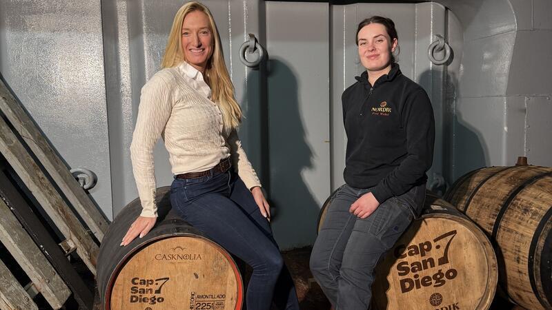Deutschlands jüngste Destillateurmeisterin kommt aus Horneburg Ann-Kathrin Ruess von der Cap San Diego (links) und Lea Weßel sitzen auf einem Nordik-Fass im Frachtraum des Schiffes.