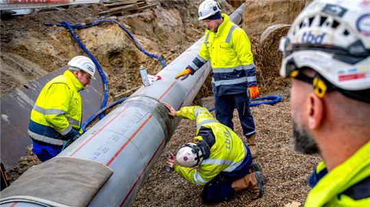 Arbeiter prüfen die letzte Schweißnaht einer weitere Anbindungspipeline für das LNG-Terminal in Wilhelmshaven.
