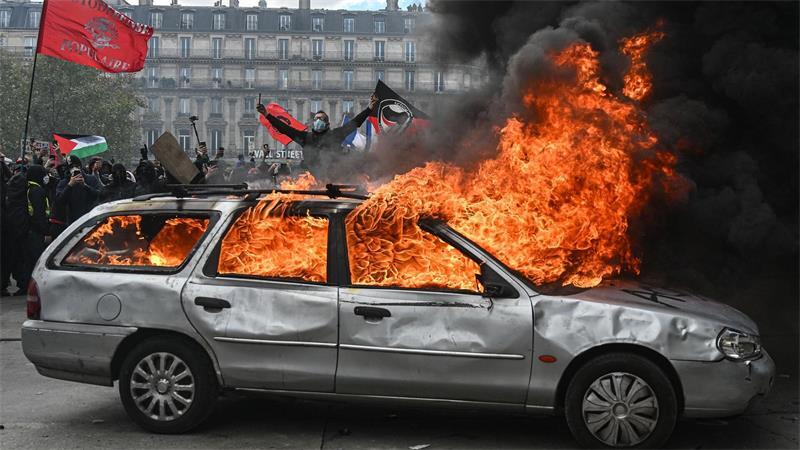 Auf dem Place de la République in Paris brennt ein Auto während es zu Zusammenstößen zwischen Demonstranten und Polizeikräften kommt.