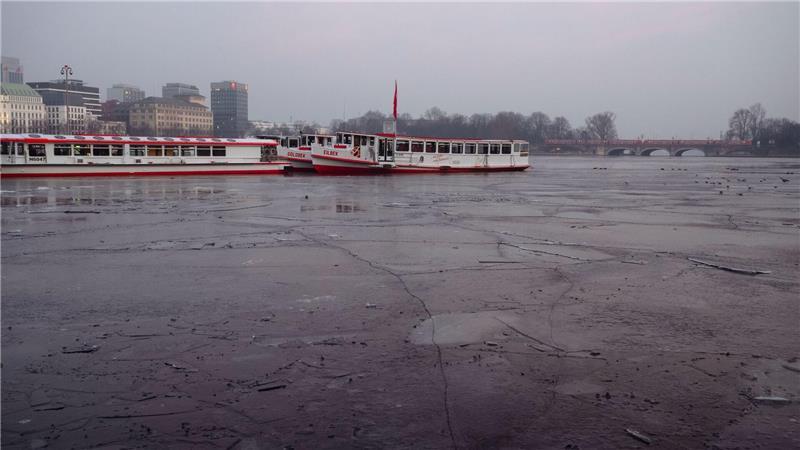 Ausflugsschiffe liegen an der teils gefrorenen Binnenalster in Hamburg. 