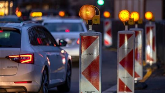 Autos fahren an einer Baustelle vorbei.
