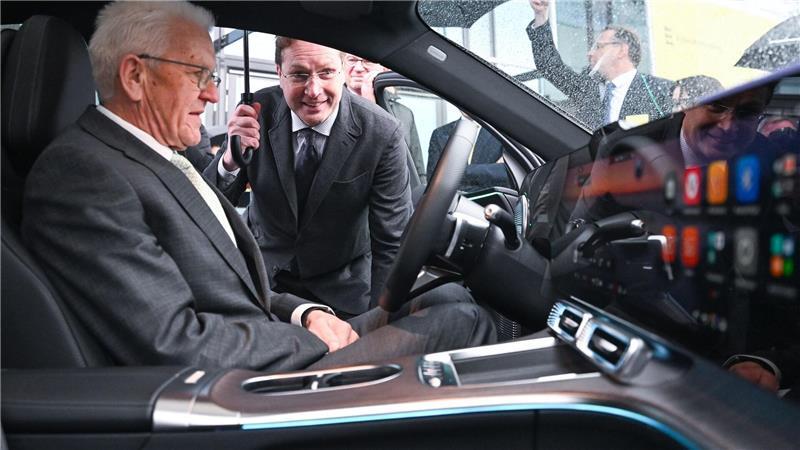 Baden-Württembergs Ministerpräsident Winfried Kretschmann bekommt das Cockpit eines Mercedes von Mercedes-Chef Ola Källenius erklärt.