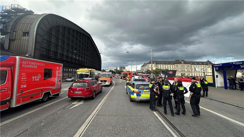 Polizisten und ein Krankenwagen stehen auf einer Straße neben dem Hamburger Hauptbahnhof.