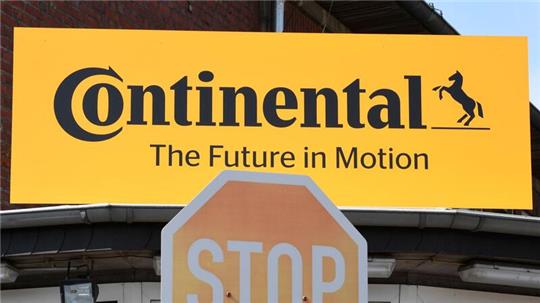 Blick auf das Logo des Reifenherstellers Continental und ein Stop-Schild.