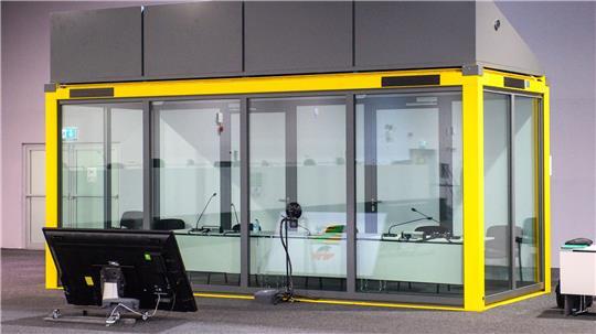 Blick auf den leeren Glaskasten im Gerichtssaal des temporären Gerichtsgebäudes vom Landgericht Magdeburg, in dem normalerweise der Todesfahrer vom Magdeburger Weihnachtsmarkt sitzt.