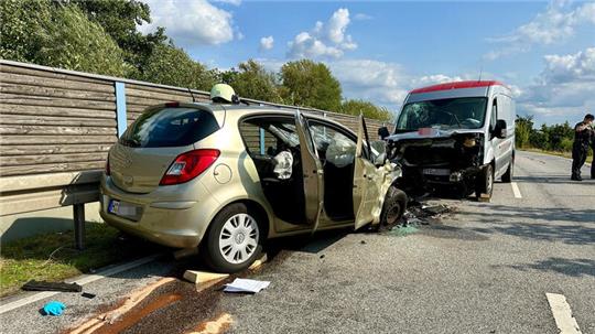 Ein beschädigtes Auto und ein beschädigter Transporter stehen auf der Straße An der Alten Süderelbe in Finkenwerder.