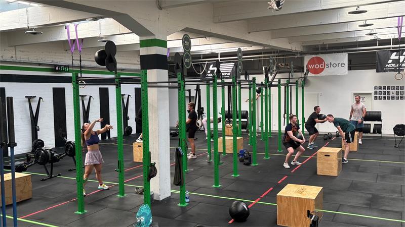 Eine Stunde beim Crossfit: Was Menschen zum Sport antreibt Box heißt die Trainingsstätte im Crossfit. Männer und Frauen trainieren in einer Gruppe.