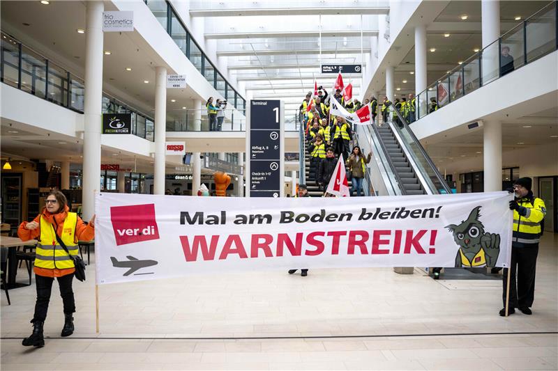 Warnstreik: Gähnende Leere am Hamburger Flughafen Bremen: Streikende Beschäftigte laufen mit Plakaten durch das Terminal vom Flughafen Bremen. Zehntausende Flugreisende müssen sich erneut auf Verspätungen und Ausfälle an mehreren Flughäfen in Deutschland einstellen. Foto: Sina Schuldt/dpa
