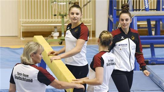 Bundestrainerin Ulla Koch (l) trainiert mit Emilie Petz (Zweite von links), Elisabeth Seitz und Pauline Schäfer, Mitglieder des deutschen Turn-Teams, am Schwebebalken für die Olympischen Spiele in Tokio. 