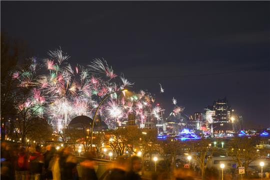 Buntes Feuerwerk ist am Himmel über der Stadt um Mitternacht zu sehen. Foto: Marcus Brandt/dpa
