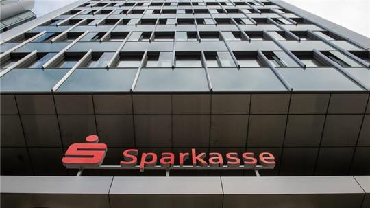 Das Logo der Sparkasse über einem Eingang zum Unternehmenssitz der Sparkasse Hannover.