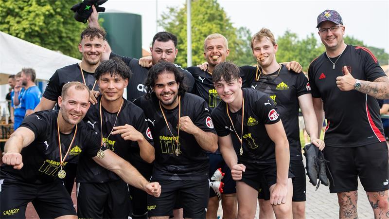 Das Team "Clever Fit" gewann das Betriebsfußballturnier in Hammah. Organisator Michael Breuer (rechts) gratuliert.