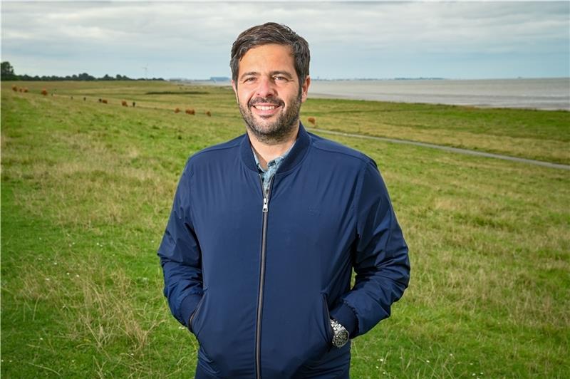 Den Otterndorfer Elbdeich hat sich SPD-Kandidat Daniel Schneider aus zwei Gründen als Treffpunkt ausgesucht: „Es ist wunderschön hier“, sagt er, „und man hat von hier den Blick auf den Offshore-Basishafen in Cuxhaven, den wir ins Zentrum un