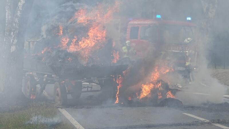 Strohballen brennen auf Anhänger – Kreisstraße gesperrt Der Anhänger steht auf der K46 in Flammen.