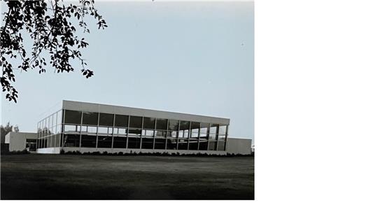 Der Blick vom Stadtpark auf das Hallenbad, das Grundgerüst mit den Glasscheiben wurde durch Anbauten ergänzt.