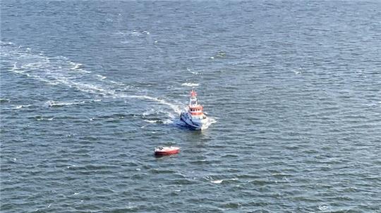 Der Cuxhavener Seenotrettungskreuzer "Anneliese Kramer" erreicht das Segelboot mit Mastbruch. Der Hubschrauber der Marineflieger kreist über die Einsatzstelle zwischen Cuxhaven und Neuwerk. Foto: Francke