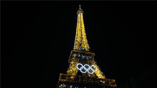 Pariser Eiffelturm während Olympia bei Nacht.