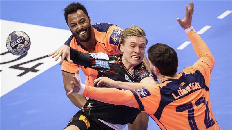 Der Magdeburger Gisli Kristjansson (M) spielt gegen Barcelonas Timothey N’Guessan (l) und Ludovic Fabregas (r) in der Champions League.