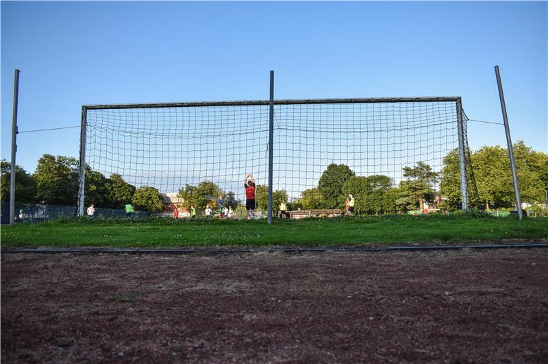 Ein Fußballtor von hinten, davor trainiert der SV Ottensen auf einer Spielhälfte.