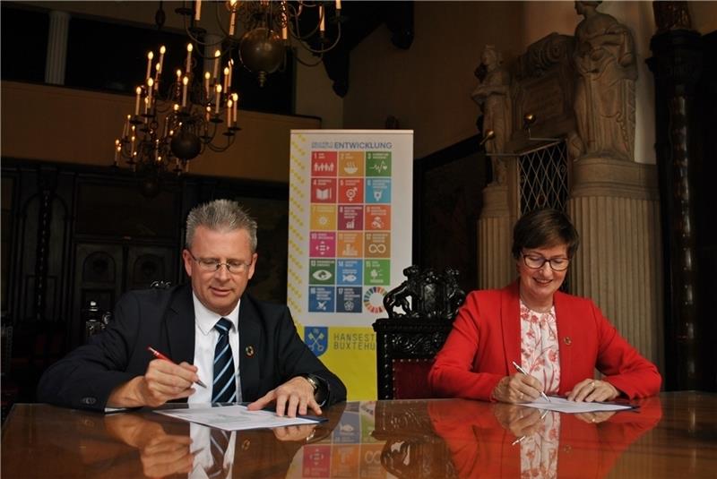 Der Ratsvorsitzende Christian Krüger und Bürgermeisterin Katja Oldenburg-Schmidt unterzeichnen die Musterresolution.