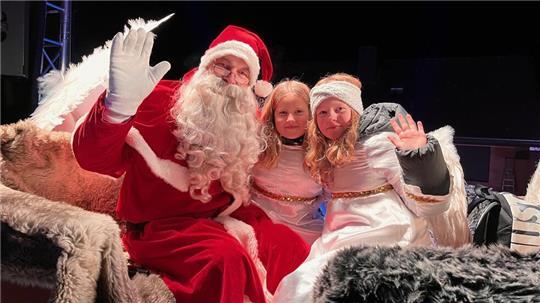 Der Weihnachtsmann in seinem Schlitten wird begleitet von seinen Engeln.