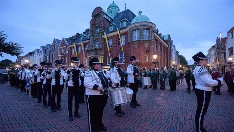 Zapfenstreich in Buxtehude: Das steckt hinter der Schützenfest-Tradition Der Zapfenstreich auf dem Rathausplatz.
