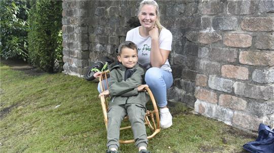 Der fünfjährige Theo freut sich über den Schaukelstuhl, den seine Mutter Anna gekauft hat.