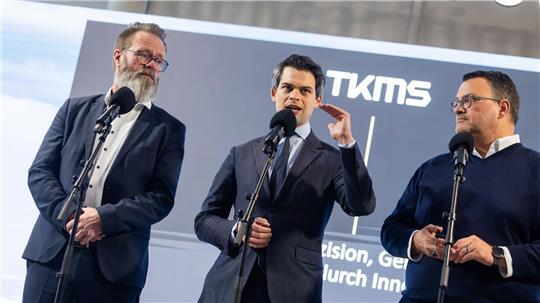 Der maritime Beauftragte der Bundesregierung, Christoph Ploß (Mitte) spricht in Kiel mit Wirtschaftsminister Claus Ruhe Madsen (links, CDU) und TKMS-Chef Oliver Burkhard.