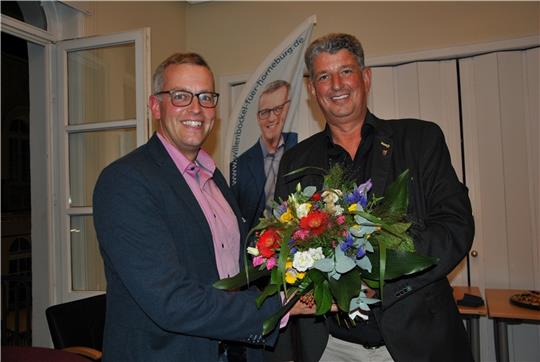 Der parteilose Verwaltungsfachmann Knut Willenbockel (links) wird neuer Bürgermeister der Samtgemeinde Horneburg: Mit einem Blumenstrauß gratulierte ihm der bisherige Rathaus-Chef Matthias Herwede zur Wahl. Foto: Lohmann