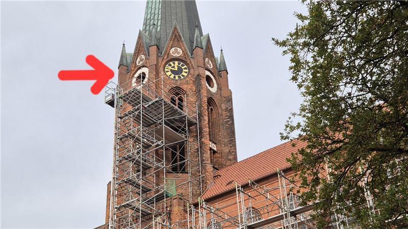 Der rote Pfeil markiert die Stelle in etwa 40 Meter Höhe am Turm der St.-Petri-Kirche, an der Handwerker Hauptauflager des Turms instand setzen.
