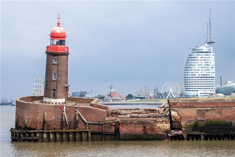 Der schief stehenden Moleturm. Teile der Nordmole in Bremerhaven sind in der Nacht zum Donnerstag eingesackt. Die Einfahrt zur Geeste ist gesperrt. Auch der Fährbetrieb der Weserfähre musste eingestellt werden. Foto: Sina Schuldt/dpa