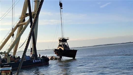 Der zerbrochene Rumpf der "Ethel von Brixham" wird vom Leitdamm in Cuxhaven auf den Ponton des Schwimmkrans "Enak" befördert.
