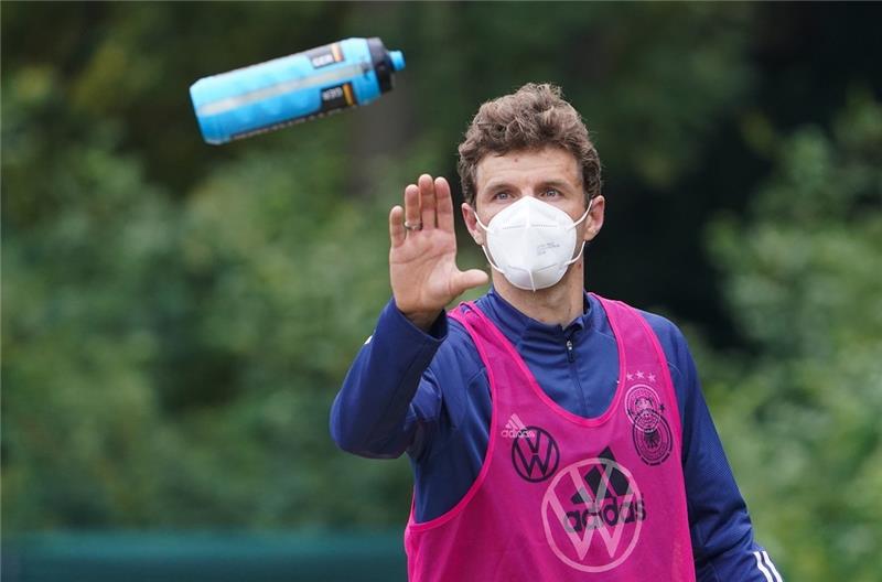 Deutschlands Thomas Müller fängt eine Trinkflasche. Foto: Marcus Brandt/dpa