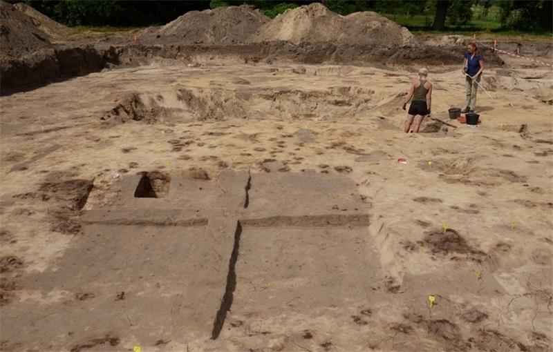 Die Baugrube in Groß Thun: Gut zu erkennen ist der viereckige Grundriss eines Pfahlhauses aus dem ersten Jahrtausend . Im Hintergrund die Archäologen und die Schwingewiesen. Fotos Strüning