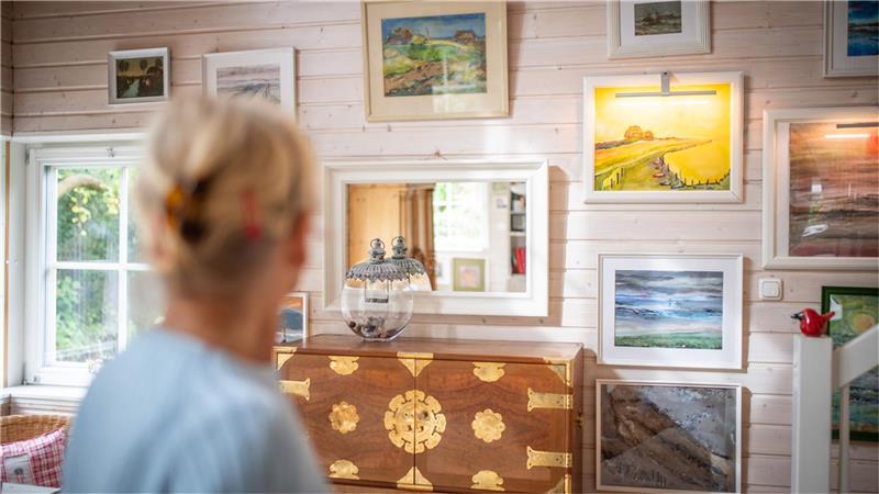 Tiny House: Das große Glück im kleinen Schwedenhaus Die Hausbesitzerin malt ihre Bilder selbst. Die Kommode hat sie aus Taiwan. Foto: Arnd Hartmann