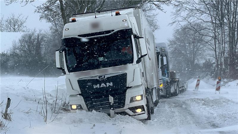 Die Lkw stecken im kniehohen Schnee fest.