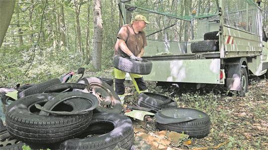 Die Reinigung illegaler Müllkippen ist mühselige Schwerstarbeit. Reifen für Reifen wuchtet Jens Klein auf die Ladefläche seines Pritschenwagens.