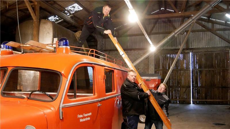 Die drei Opel-Blitz-Fans freuen sich, dass die hölzerne originale Feuerleiter noch vorhanden ist.