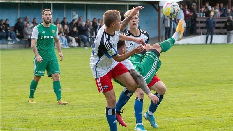 Oberligist Heeslinger SC verliert gegen HSV-A-Junioren Dimitrios Ferfelis versucht, mit einer akrobatischen Einlage zum Erfolg zu kommen. Im Hintergrund verfolgt der Buxtehuder Nico Mattern die Aktion seines Mitspielers. Foto: Demmer