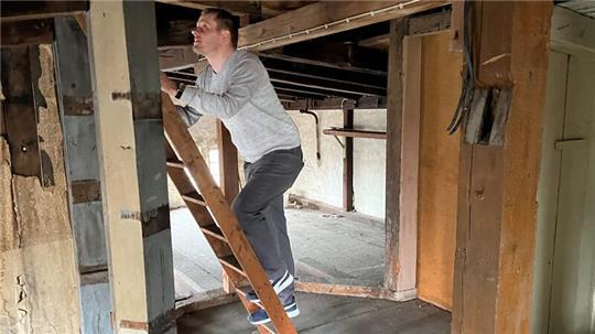 Dr. Sebastian Ipach klettert nach oben. Zu erkennen ist das Turmfundament der alten Sternwarte mit der Vertiefung für ein Wendeltreppenauflager und der Kerbe der ersten Treppenstufe.