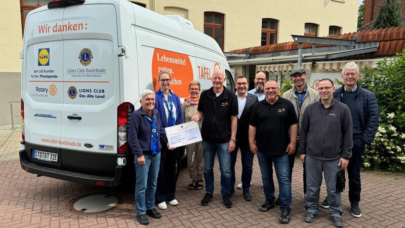 Buxtehuder Tafel: Kommt der neue Ausgabetag für Senioren an? Ehrenamtliche, Förderer und Sponsoren der Buxtehuder Tafel stehen bei dem neuen Fahrzeug für den Lebensmitteltransport. 90.000 Euro hat der Ford Transit mit Elektromotor gekostet.