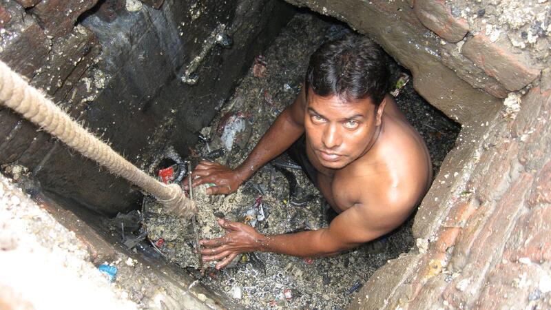 Einer der dreckigsten Jobs der Welt: Kanalreiniger in Indien Ein Kanalreiniger arbeitet in einem Außenbezirk von Neu Delhi in der Kanalisation - ohne Schutzkleidung.