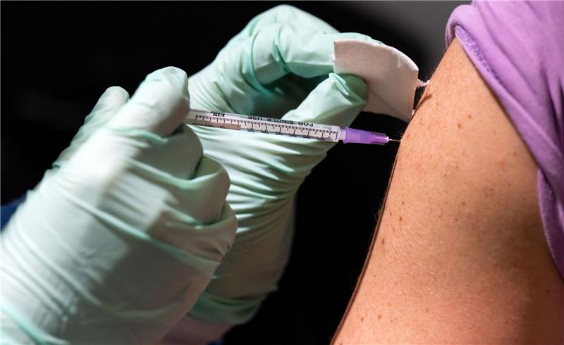 Ein Mann lässt sich im Corona-Impfzentrum Berlin-Tegel eine Booster-Impfung geben.