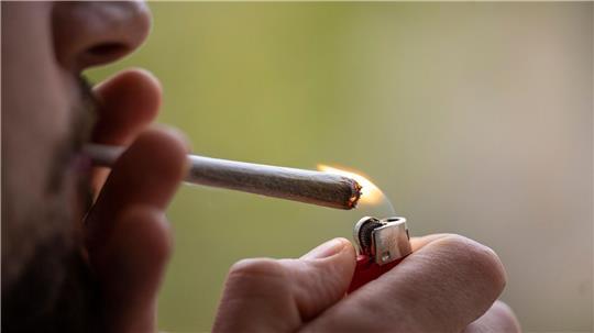 Ein Mann zündet sich einen Joint an. (zu dpa: «Cannabis-Schwarzmarkt bisher kaum verdrängt»)