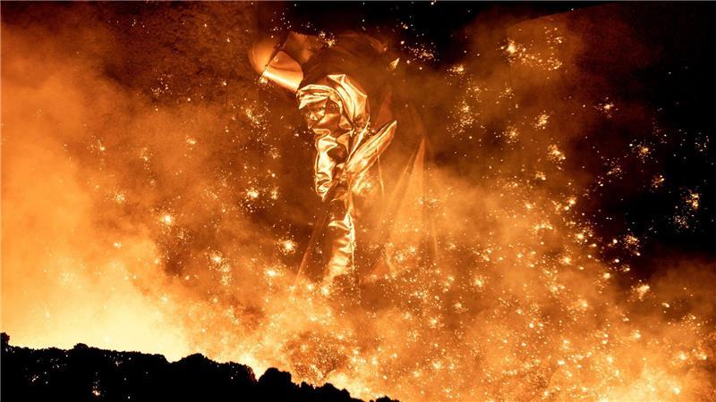 Salzgitter beendet Übernahmegespräche mit Konsortium Ein Mitarbeiter reinigt in einem Stahlwerk die Abstichrinne am Hochofen.