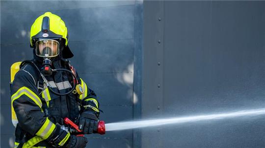 Ein Mitglied der Feuerwehr beim Löscheinsatz.